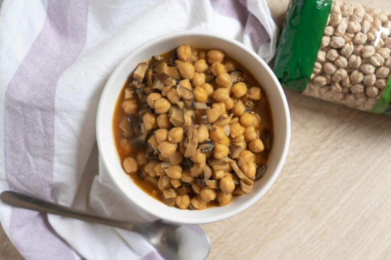 A delicious bowl of chickpeas cooked with mushrooms, highlighting healthy eating.